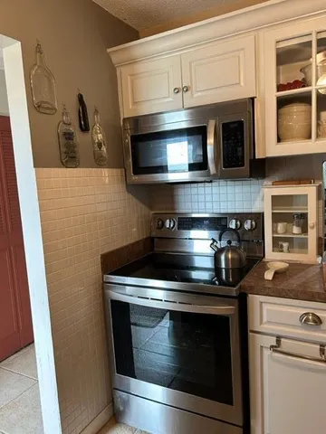 a stove top oven sitting inside of a kitchen