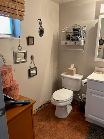 a white toilet sitting next to a bathroom sink