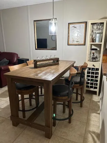 a view of a dining room with furniture and a mirror