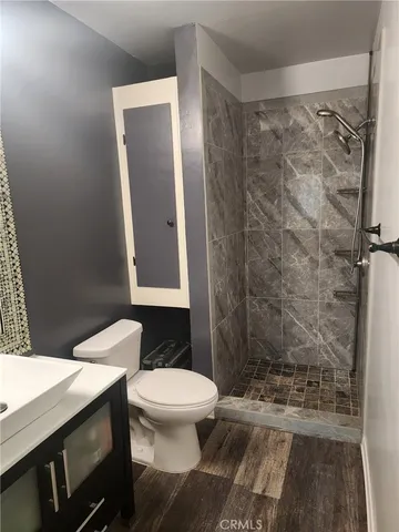 a bathroom with a toilet and a shower