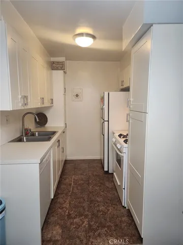 a kitchen with a sink and refrigerator