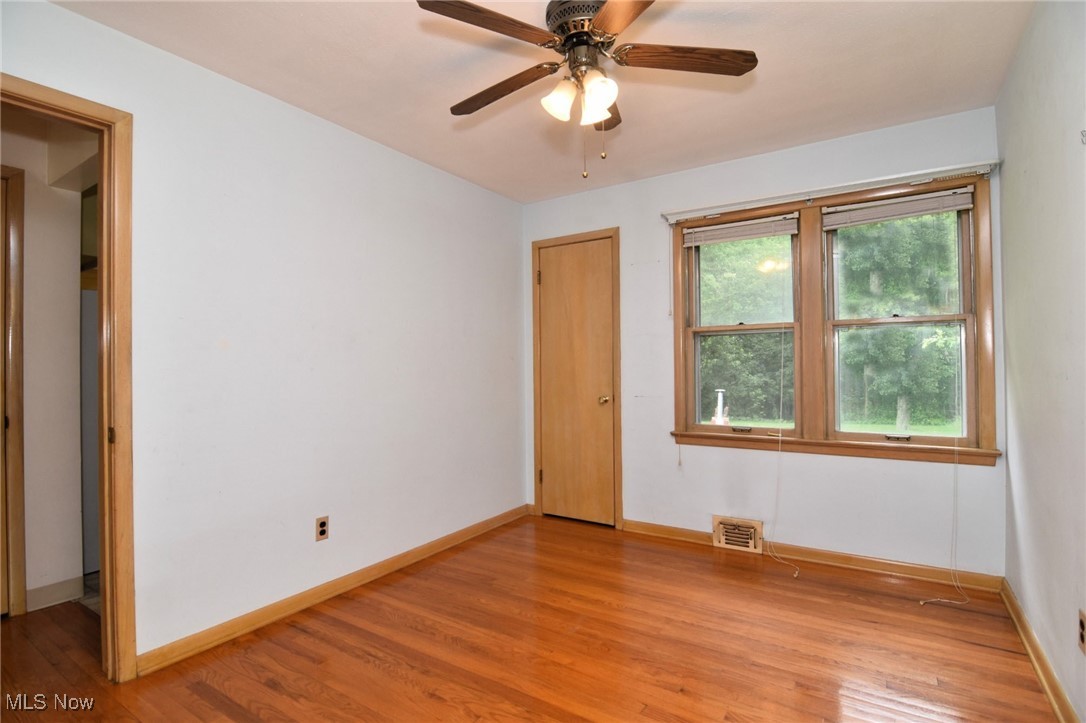 9421 David Road Cleveland, OH 44125 - Photo 20 of 36 Empty room with light wood finished floors and ceiling fan