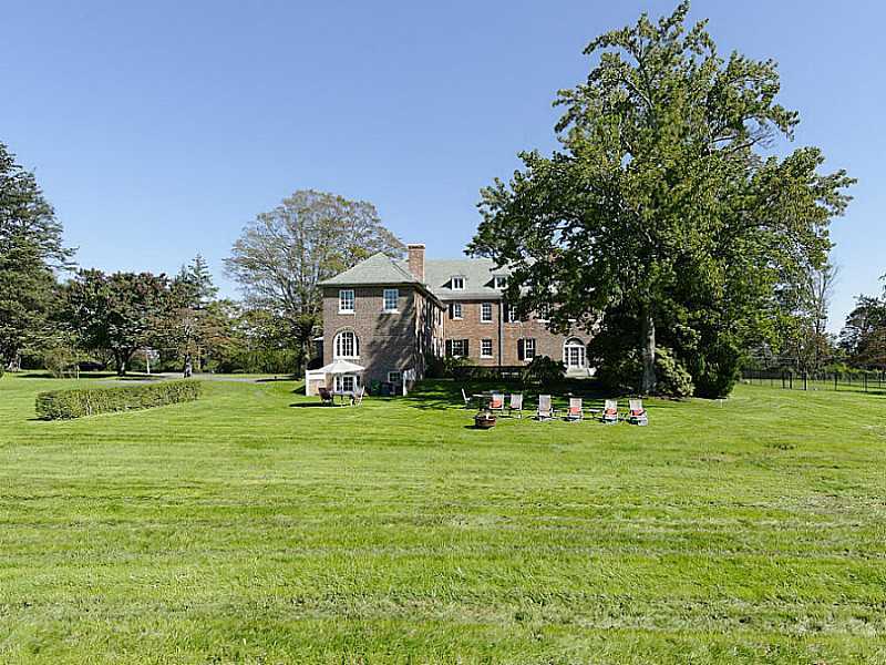 487 North Street Greenwich, CT 06830 - Photo 7 of 10 a front view of a house with a yard and trees