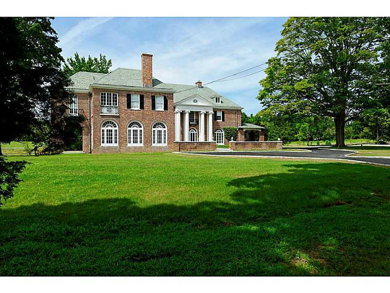 487 North Street Greenwich, CT 06830 - Photo 10 of 10 a front view of a house with a garden