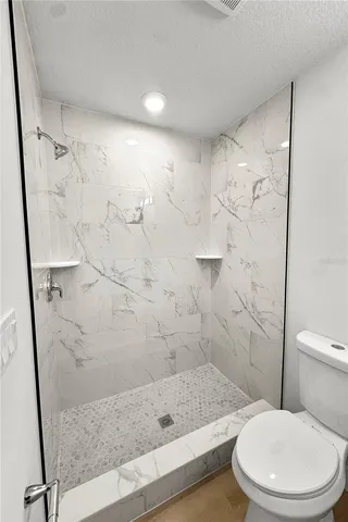 a bathroom with a toilet and shower