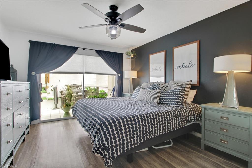 3342 Timberwood Circle Naples, FL 34105 - Photo 16 of 25 a bedroom with a large bed and a chandelier