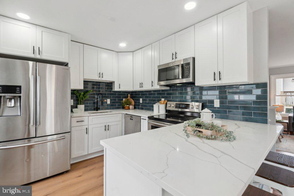 18 Rollwin Road Baltimore, MD 21244 - Photo 11 of 27 a kitchen with stainless steel appliances a refrigerator stove microwave and cabinets