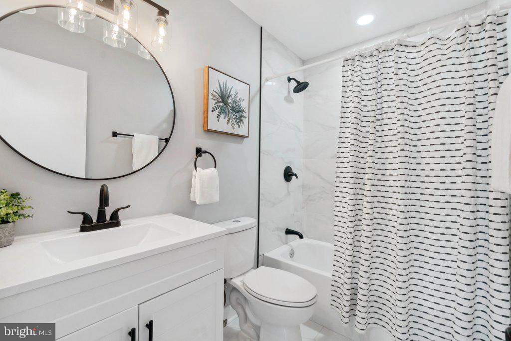 18 Rollwin Road Baltimore, MD 21244 - Photo 16 of 27 a bathroom with a toilet sink and mirror