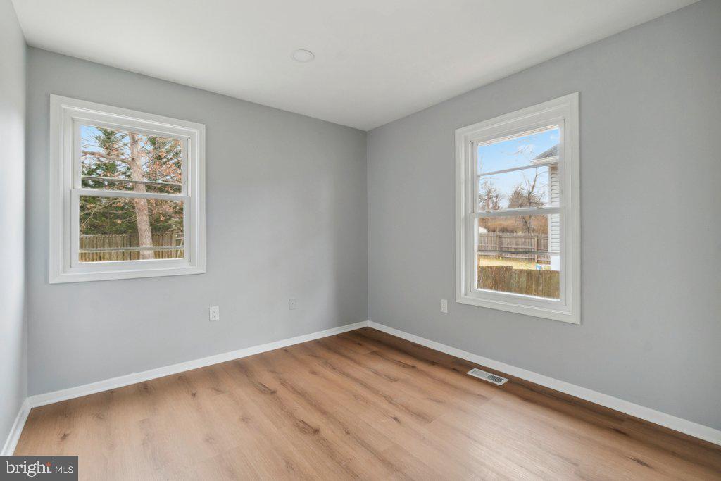 18 Rollwin Road Baltimore, MD 21244 - Photo 17 of 27 a view of an empty room with wooden floor and a window