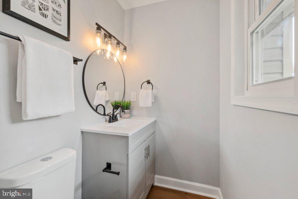 18 Rollwin Road Baltimore, MD 21244 - Photo 20 of 27 a bathroom with a sink vanity mirror and toilet