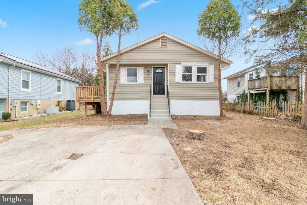 18 Rollwin Road Baltimore, MD 21244 - Photo 4 of 27 a front view of a house with a yard and garage