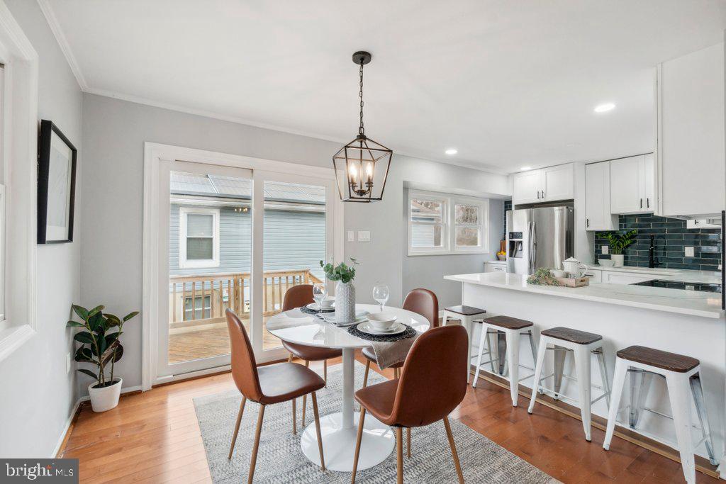18 Rollwin Road Baltimore, MD 21244 - Photo 8 of 27 a dining room with furniture potted plants and wooden floor