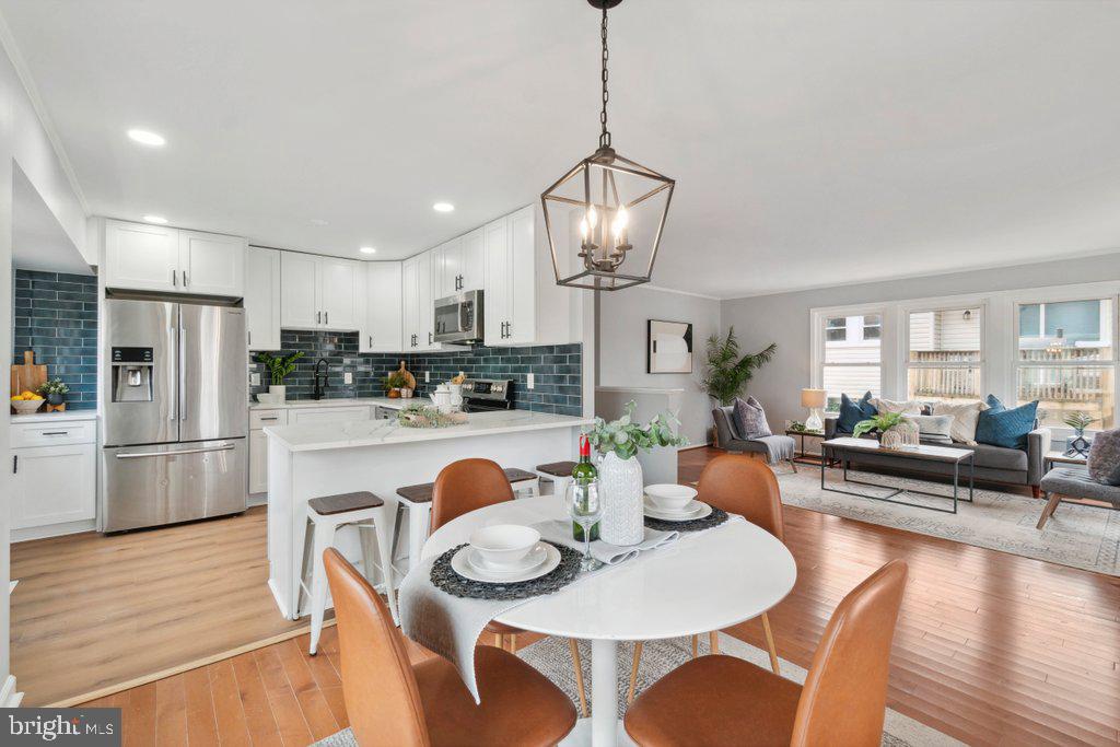 18 Rollwin Road Baltimore, MD 21244 - Photo 9 of 27 a open dining room with stainless steel appliances furniture a dining table and chairs