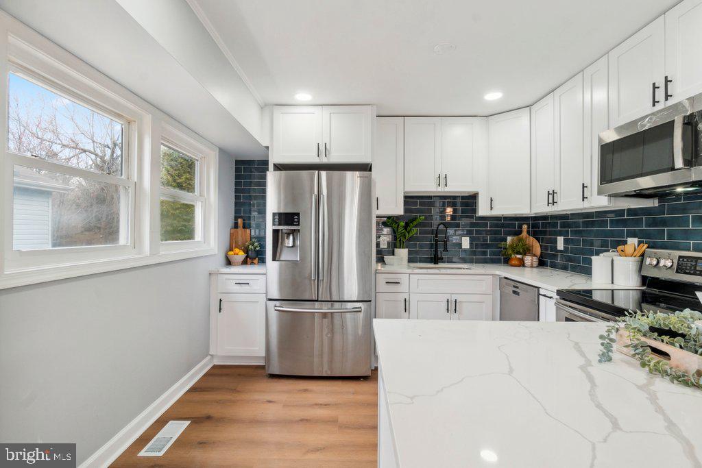 18 Rollwin Road Baltimore, MD 21244 - Photo 10 of 27 a kitchen with stainless steel appliances refrigerator sink and microwave