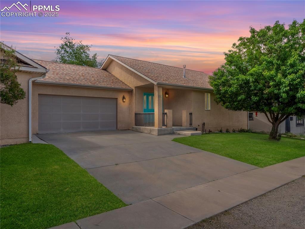 a front view of house with yard and green space