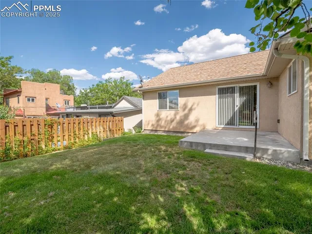 a view of a house with a yard and a garden