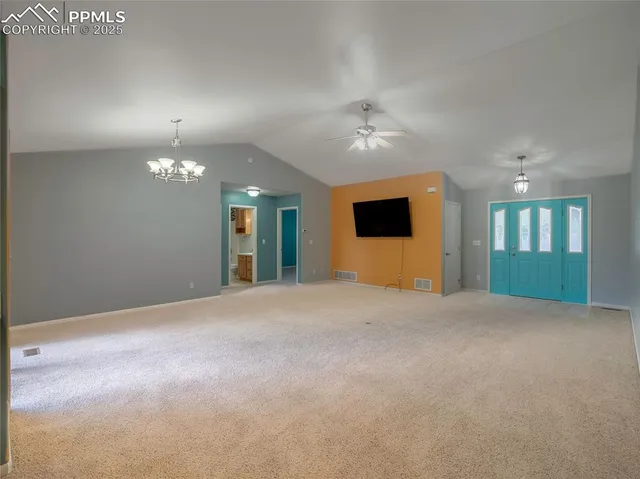 a view of an empty room with a kitchen