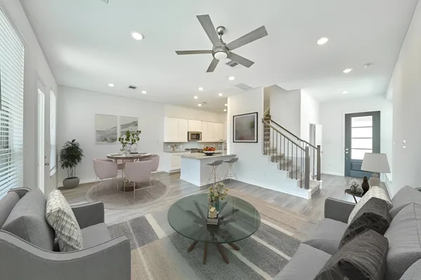a living room with furniture and a view of kitchen