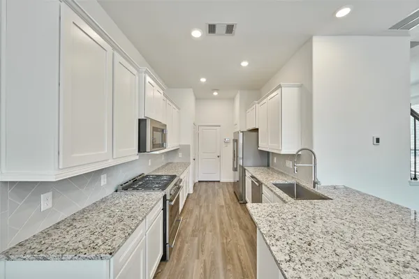 a view of kitchen with cabinets and wooden floor