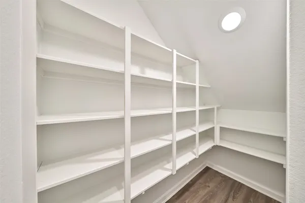 a view of walk in closet with empty racks