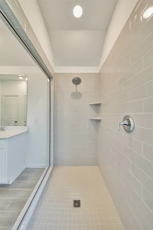a bathroom with a double vanity sink and mirror with shower