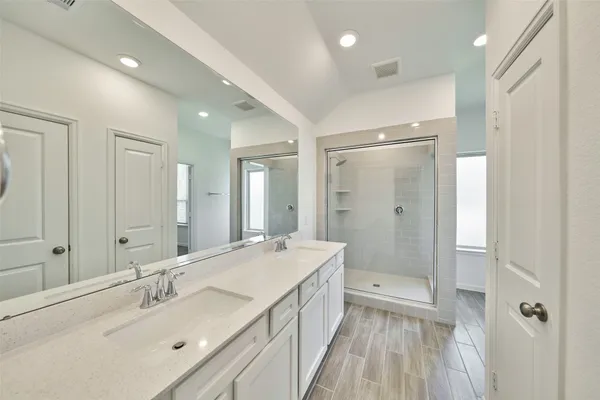 a spacious bathroom with a double vanity sink mirror and double