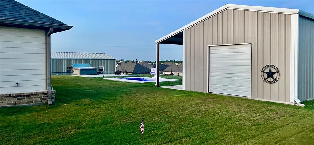 150 Spanish Moss Trail Rhome, TX 76078 - Photo 28 of 30 Backyard of shop and spring grass