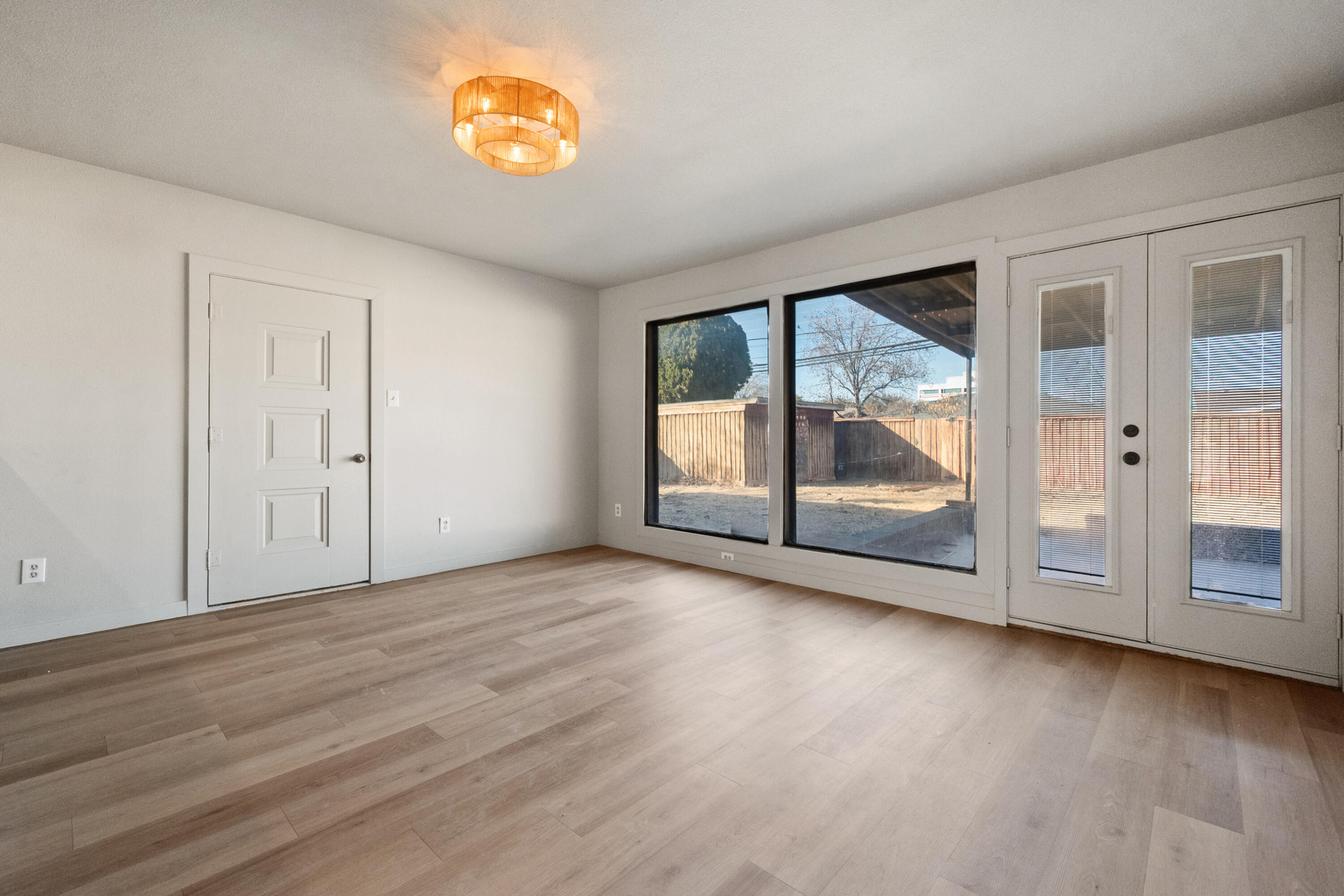 2504 53rd Street Lubbock, TX 79413 - Photo 13 of 28 a view of an empty room with wooden floor and a window