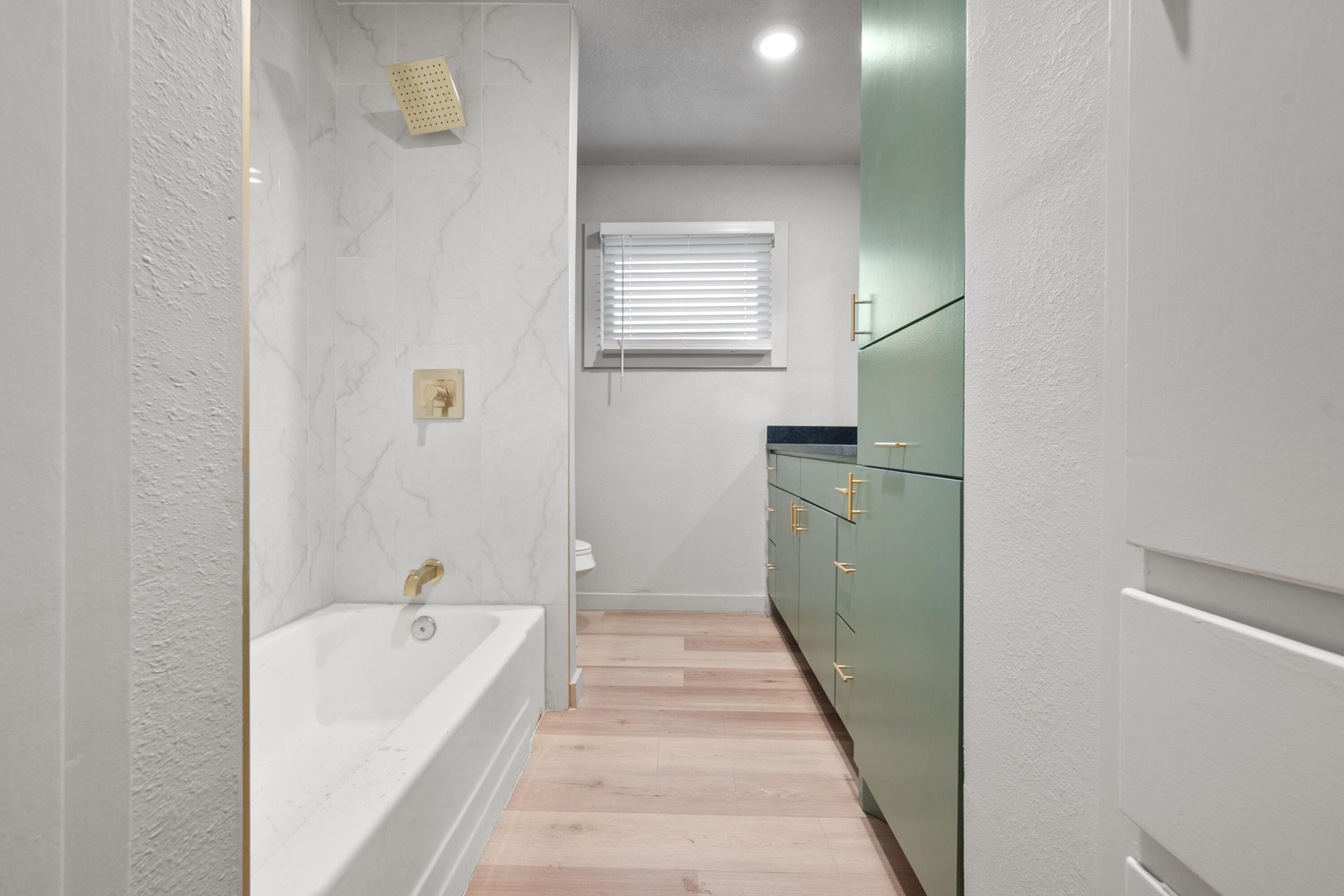 2504 53rd Street Lubbock, TX 79413 - Photo 19 of 28 a bathroom with a tub sink and mirror