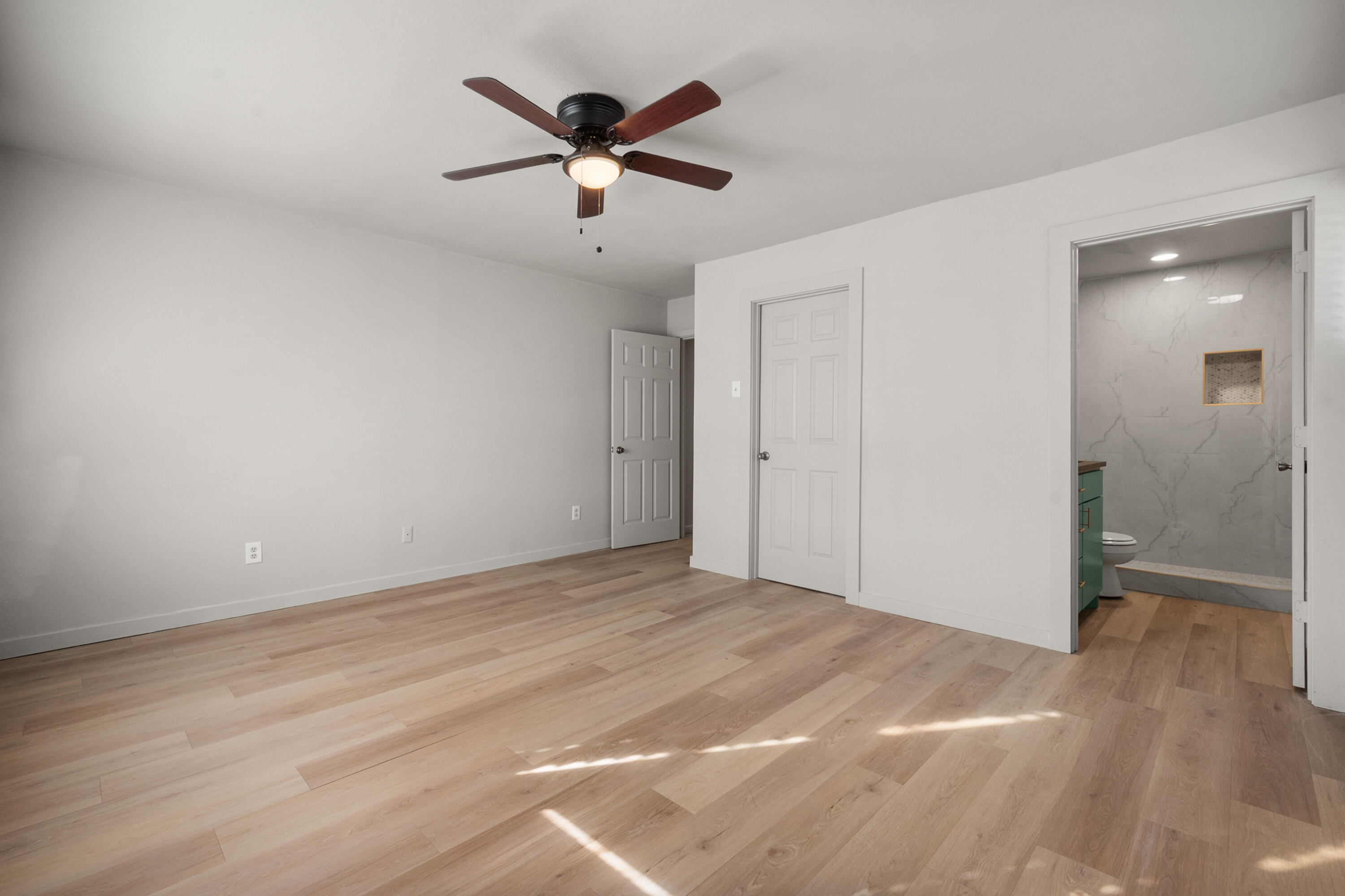 2504 53rd Street Lubbock, TX 79413 - Photo 24 of 28 an empty room with wooden floor and windows