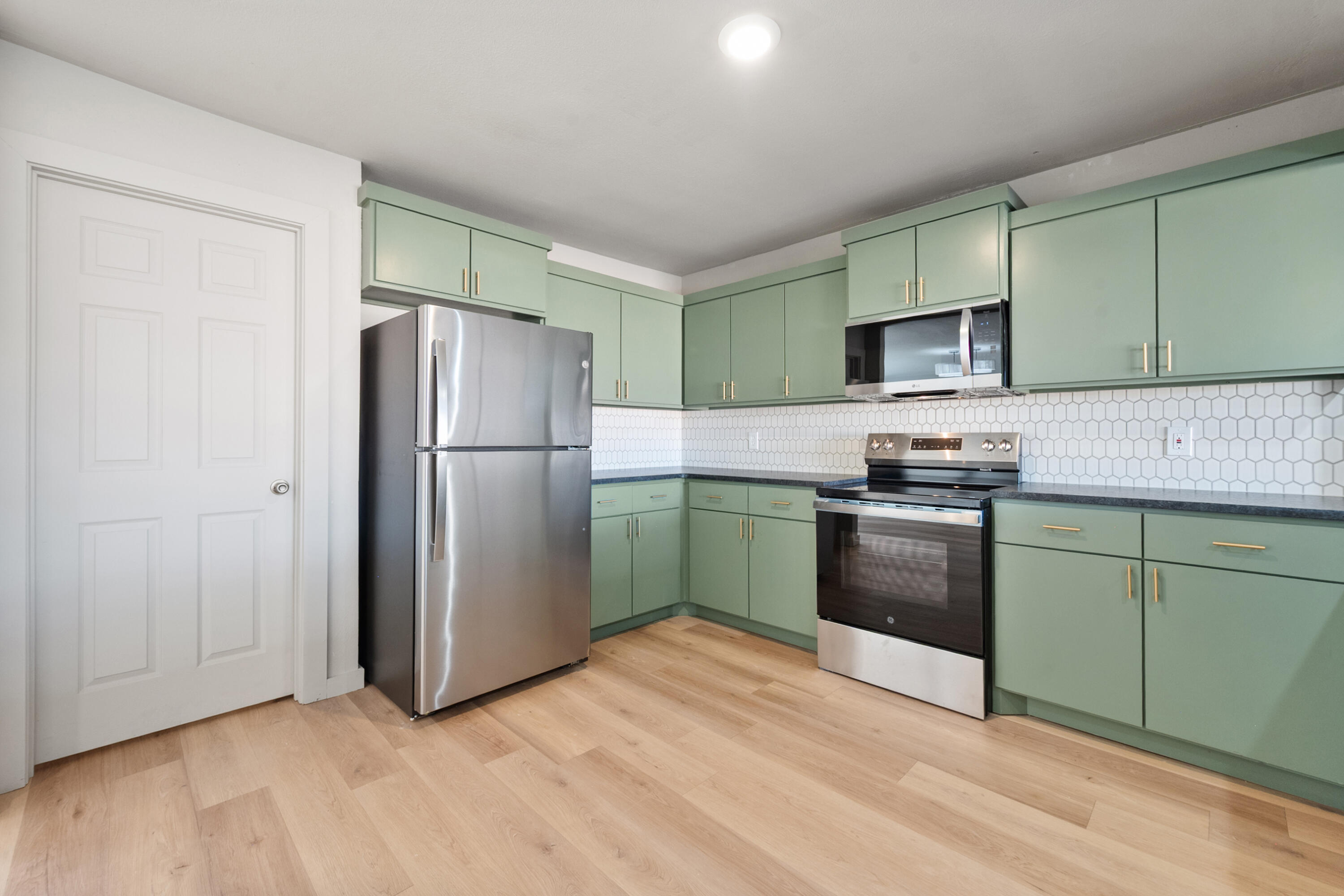 2504 53rd Street Lubbock, TX 79413 - Photo 7 of 28 a kitchen with granite countertop a refrigerator and a sink
