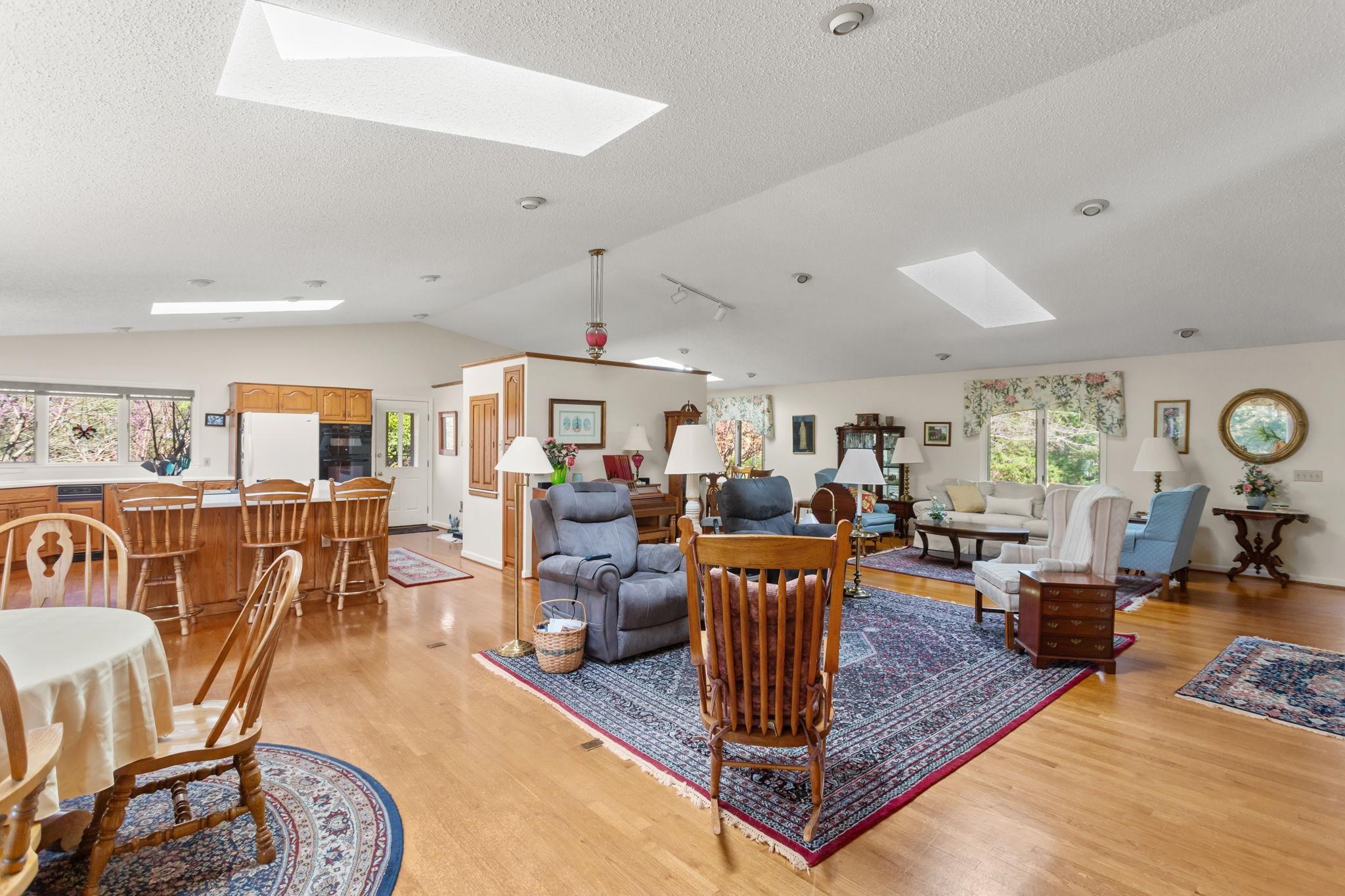13004 Indian Trail Road Broadway, VA 22815 - Photo 8 of 56 a living room with furniture a table and kitchen view