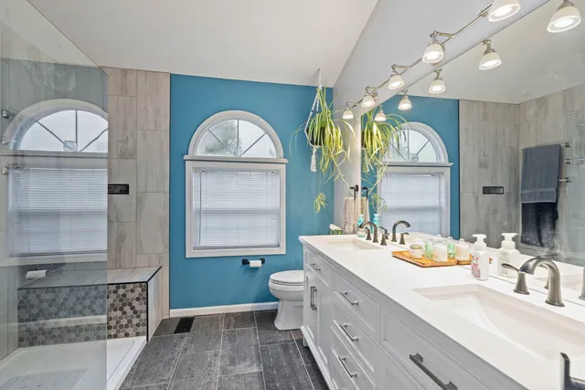 a bathroom with a double vanity sink and a mirror