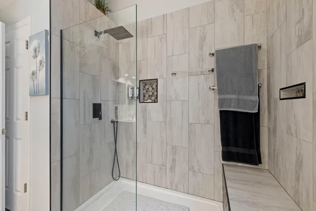 a bathroom with a shower and a glass door