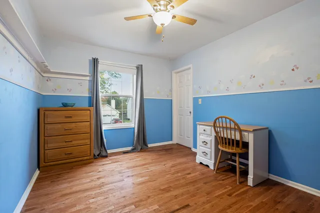 an empty room with furniture and wooden floor