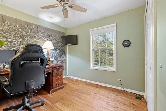 a workspace with wooden floor and windows