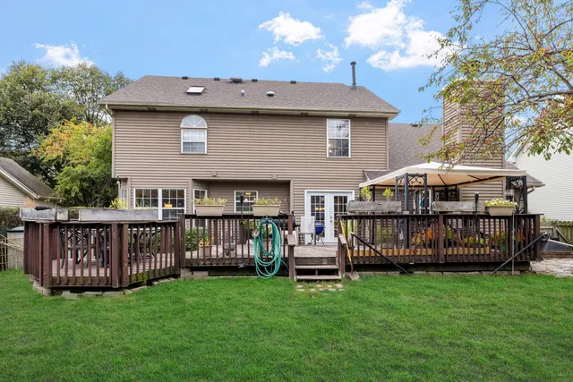 a view of a deck with a table and chairs with wooden fence