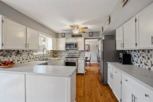 a kitchen with cabinets a sink and appliances