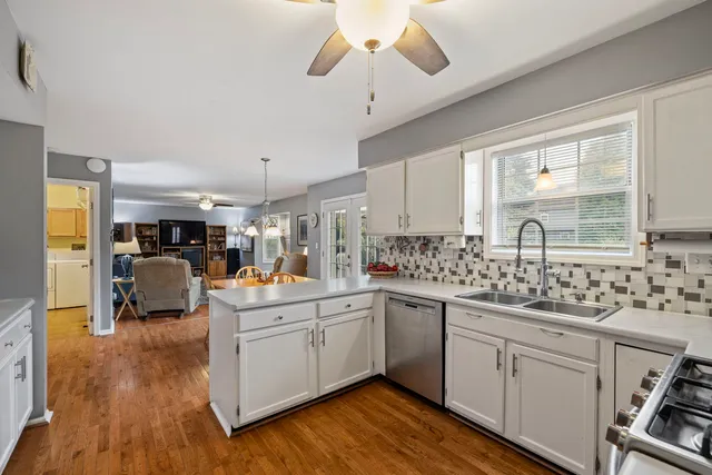 a kitchen with sink cabinets and wooden floor