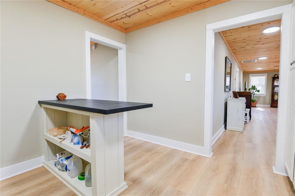 1160 Moody Street Union Point, GA 30669 - Photo 18 of 39 a view of a hallway with wooden floor and a bathroom