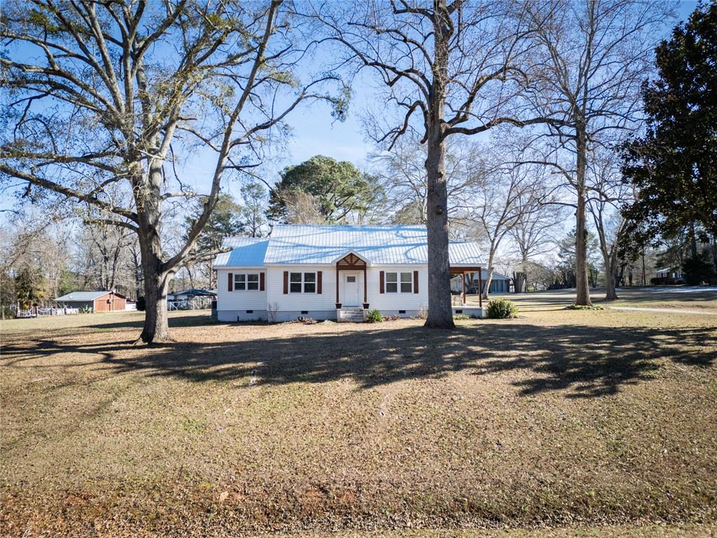 1160 Moody Street Union Point, GA 30669 - Photo 2 of 39 a view of a house with a yard covered with snow