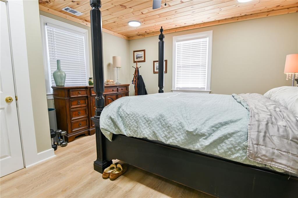 1160 Moody Street Union Point, GA 30669 - Photo 24 of 39 a bedroom with a bed and a dresser next to a window