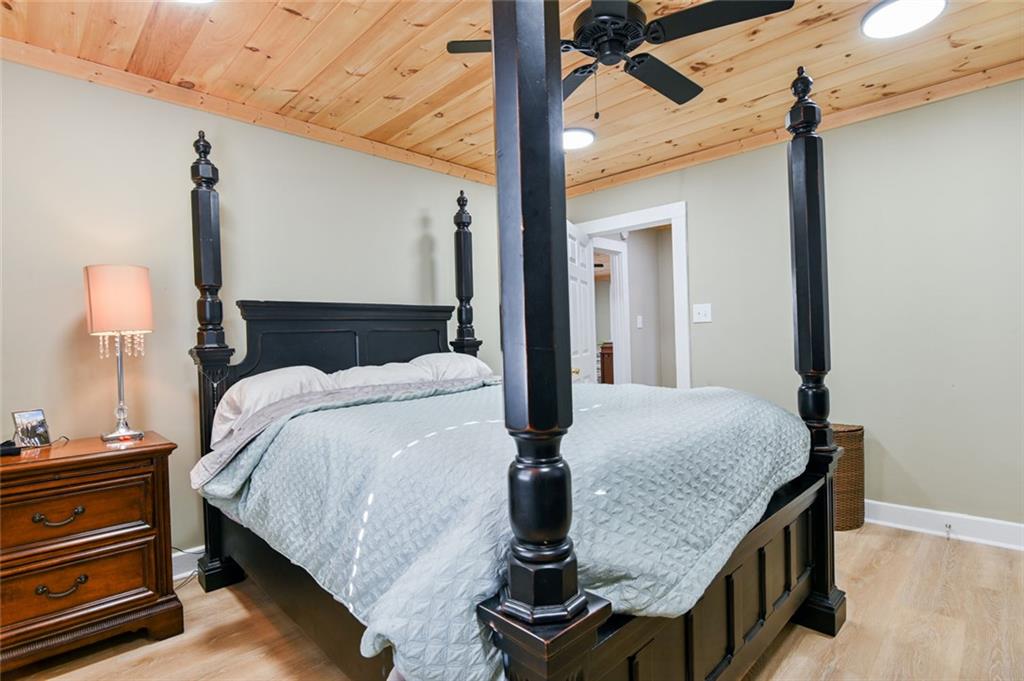 1160 Moody Street Union Point, GA 30669 - Photo 26 of 39 a bedroom with a bed and dresser with wooden floor