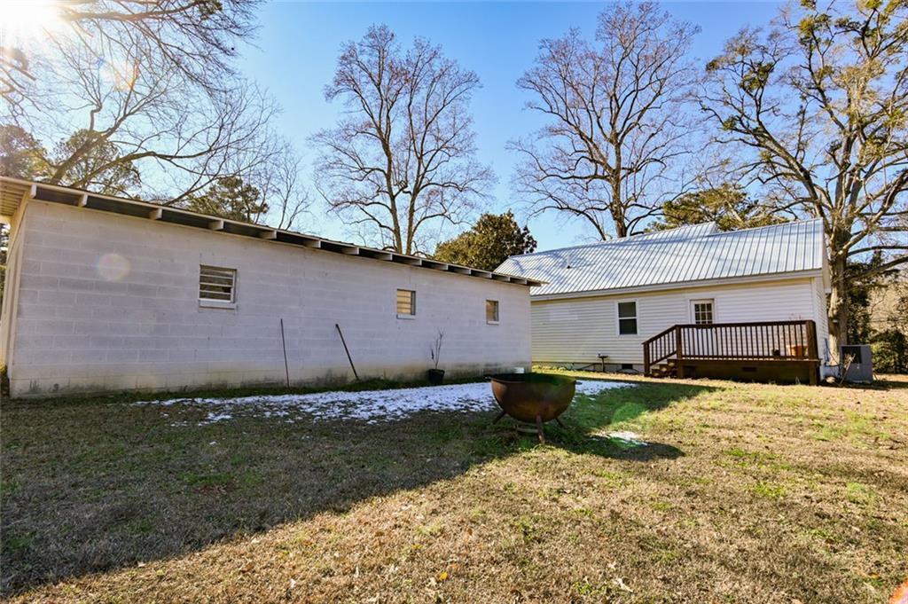 1160 Moody Street Union Point, GA 30669 - Photo 35 of 39 a backyard of a house with wooden fence and large trees