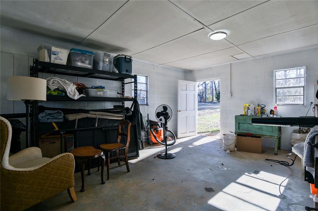 1160 Moody Street Union Point, GA 30669 - Photo 37 of 39 a living room with furniture a bookshelf and a window