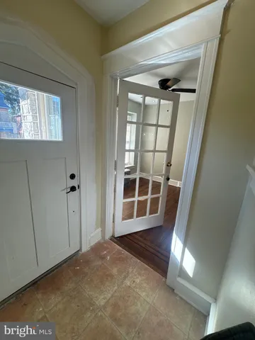 a large kitchen with stainless steel appliances a large counter top a stove and a wooden floors