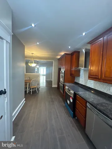 a kitchen with granite countertop a refrigerator and a sink