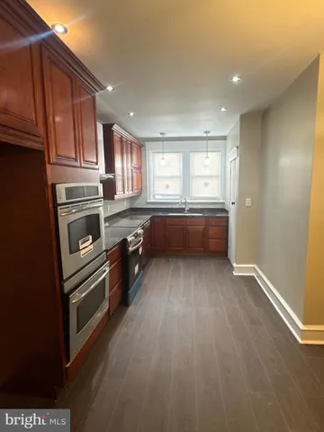 a kitchen with a table chairs stove and microwave