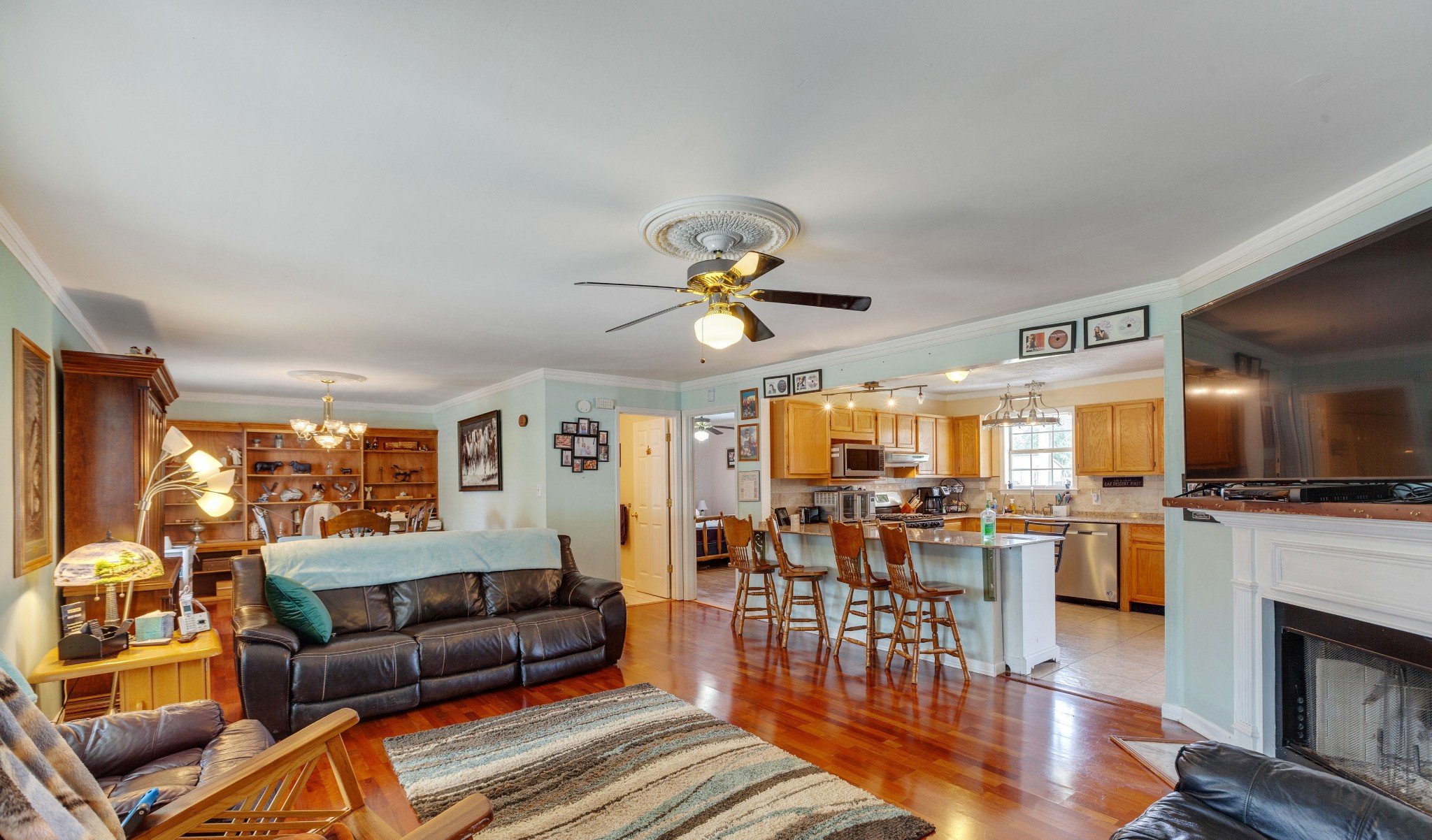 1370 McCool Road Lewisburg, TN 37091 - Photo 4 of 19 a living room with furniture a flat screen tv and kitchen view