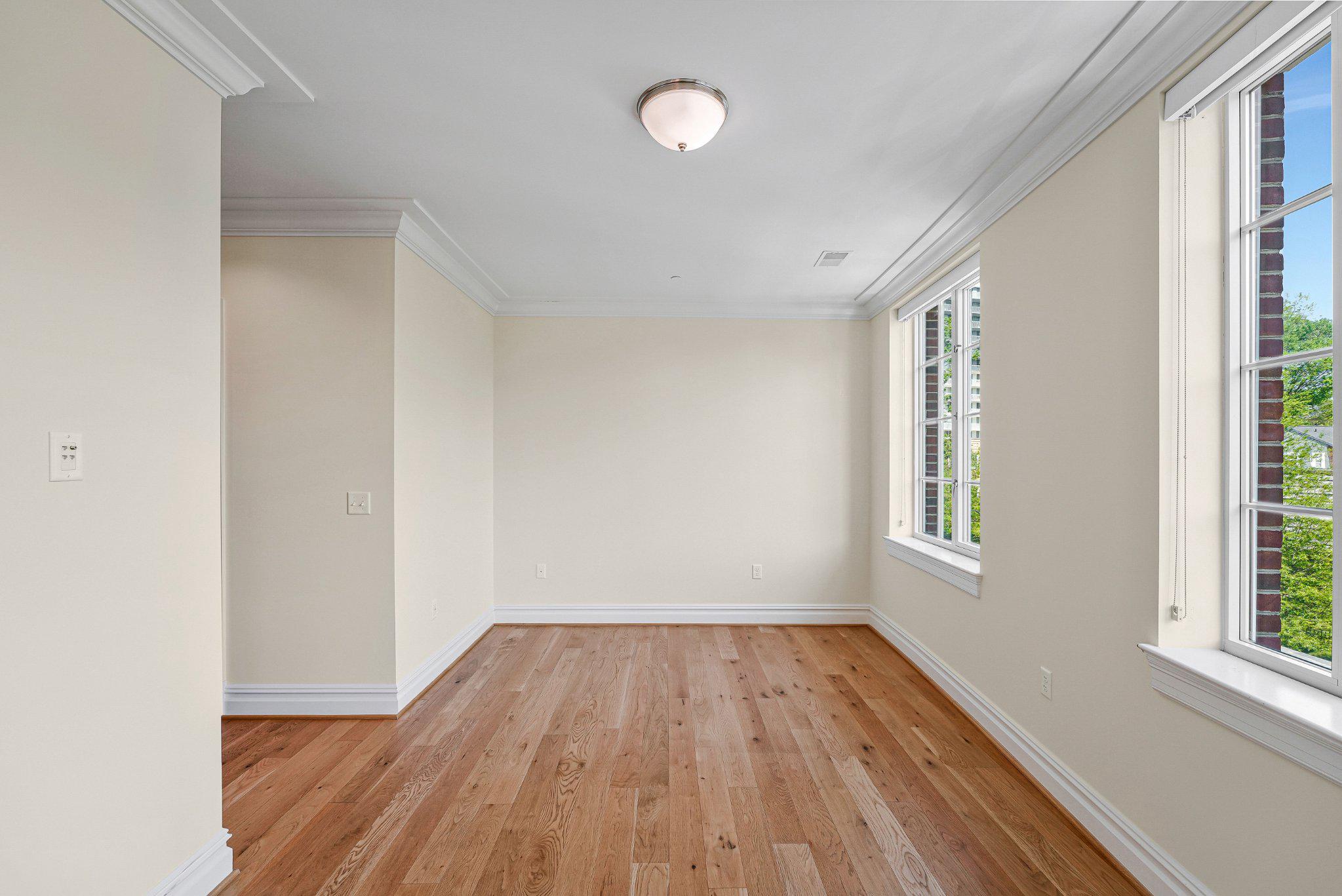 6900 Fleetwood Road, Unit 318 McLean, VA 22101 - Photo 21 of 63 an empty room with wooden floor and windows
